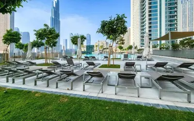 a group of chairs and tables in a park at Brand New Elegant 1BDR Direct Access to Dubai Mall in Dubai