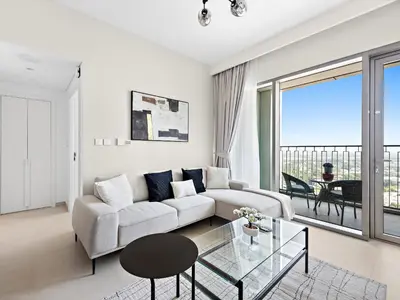 a living room with a couch and a glass table at Brand New Elegant 1BDR Direct Access to Dubai Mall in Dubai
