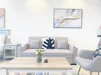 a living room with a couch and a coffee table at RH- Beautiful Canal View, Cozy studio near metro station in Dubai