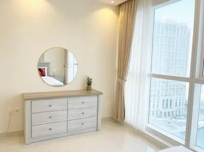 a bathroom with a dresser with a mirror and a window at RH- Beautiful Canal View, Cozy studio near metro station in Dubai