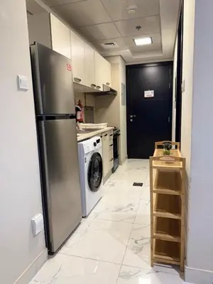a kitchen with a refrigerator and a washing machine at StoneTree - Cozy and Modern 1 BR in Dubai