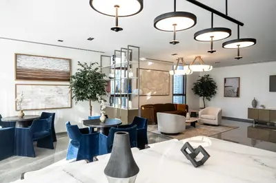 a lobby with blue chairs and tables at Sky High Gem in Central Dubai with Burj Khalifa and Fountain Views in Dubai
