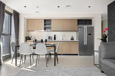 a kitchen and dining room with a table and chairs at Sky High Gem in Central Dubai with Burj Khalifa and Fountain Views in Dubai