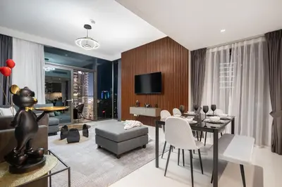 a living room with a dining table and a couch at Sky High Gem in Central Dubai with Burj Khalifa and Fountain Views in Dubai