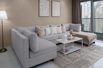 a living room with a couch and a table at Burj Khalifa Views 2BR with Infinity Pool Downtown in Dubai