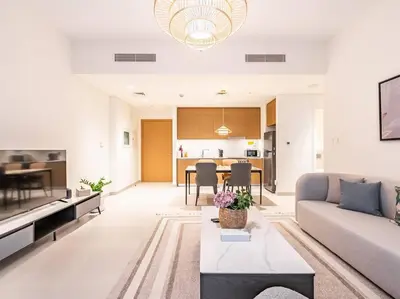 a living room with a couch and a table at Coastal Charm Casita : 1BR Creek Beach Elegance in Dubai