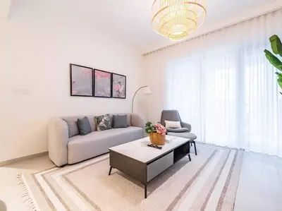 a living room with a couch and a coffee table at Coastal Charm Casita : 1BR Creek Beach Elegance in Dubai