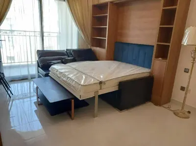 a bedroom with a bed and a couch in a room at StoneTree - Comfortable Studio in Arjan in Dubai