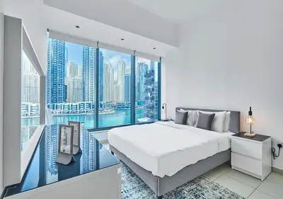 a bedroom with a large white bed and a large window at Luxury 1BR Apartment in the heart Marina, Connection to Dubai Marina Mall - Silverene tower in Dubai