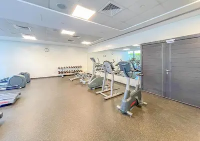 a gym with several treadmills and machines in it at Luxury 1BR Apartment in the heart Marina, Connection to Dubai Marina Mall - Silverene tower in Dubai