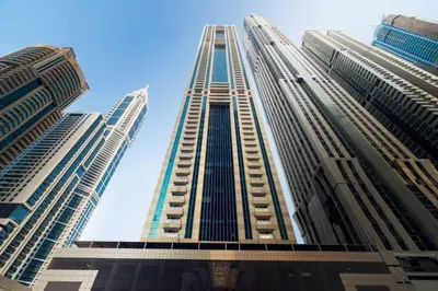a tall building looking up into the sky at GuestReady - The Reflections at Dubai Marina in Dubai