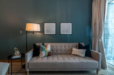 a living room with a couch with pillows at GuestReady - The Reflections at Dubai Marina in Dubai