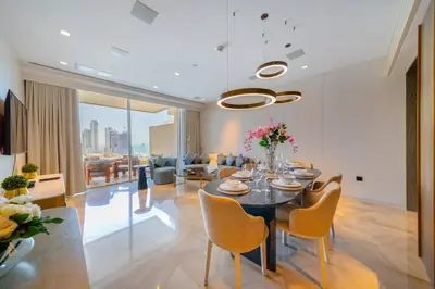 a living room with a dining room table and chairs at *Five Palm* 2bdr Private Beach in Dubai