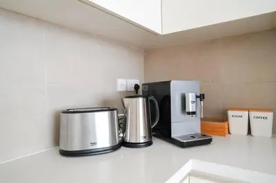 two coffee machines sitting on a counter in a kitchen at Your Elegance at Creek Harbour l 2BR in Dubai