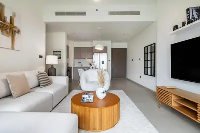 a living room with a couch and a table at Downtown Dubai- 2BR Apartment in ACT Towers in Dubai