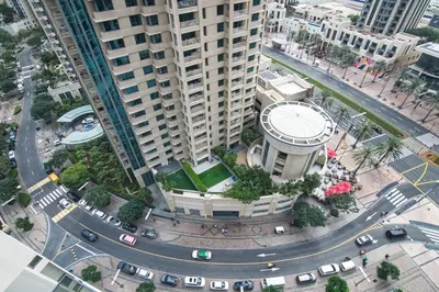 an overhead view of a building with a circular road at Downtown Dubai- 2BR Apartment in ACT Towers in Dubai