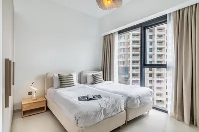 a bedroom with a large bed and a large window at Downtown Dubai- 2BR Apartment in ACT Towers in Dubai