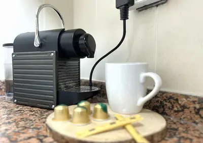 a coffee maker and a cup on a counter at Lake View 1BR Apt Balcony & Near DMCC Metro in Dubai