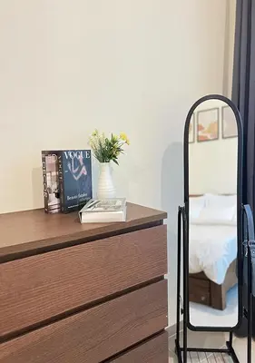 a bedroom with a desk with a bed and a chair at Lake View 1BR Apt Balcony & Near DMCC Metro in Dubai
