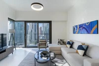 a living room with a couch and a table at Charming 2BR in Burj Crown, Walk to Burj Khalifa - Allsopp&Allsopp in Dubai