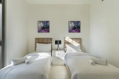 a room with three beds and a desk in it at Charming 2BR in Burj Crown, Walk to Burj Khalifa - Allsopp&Allsopp in Dubai