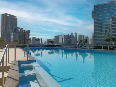a large swimming pool in a city with tall buildings at Charming 2BR in Burj Crown, Walk to Burj Khalifa - Allsopp&Allsopp in Dubai