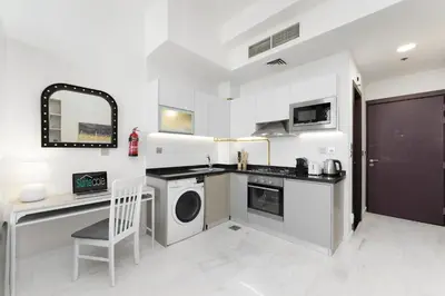 a kitchen with a washer and dryer in a room at Our Studio Jewel in Business Bay in Dubai