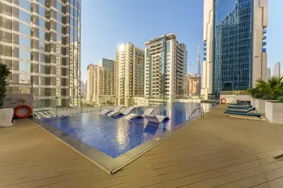 a swimming pool in a city with tall buildings at Our Studio Jewel in Business Bay in Dubai