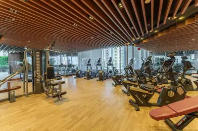 a gym with a lot of treadmills and exercise bikes at Our Studio Jewel in Business Bay in Dubai