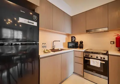 a kitchen with a sink and a stove top oven at Lux 1 BD Apartment, 2 Min walk to Dubai Mall & Burj Khalifa - Act One Tower in Dubai