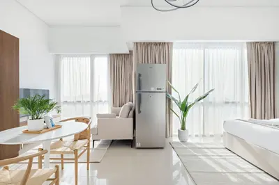a kitchen and living room with a refrigerator at Silkhaus Luxury Studio in Residential Neighborhood in Dubai