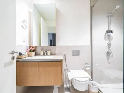 a bathroom with a sink and a shower and a toilet at Zen Oasis : 1BR Splendid Creek Side Retreat - Beach in Dubai