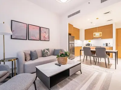 a living room with a couch and a table at Zen Oasis : 1BR Splendid Creek Side Retreat - Beach in Dubai