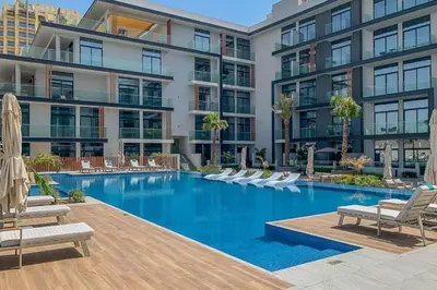 an image of a swimming pool at a building at HAVN - Smart Home Studio in Oxford 212, JVC in Dubai