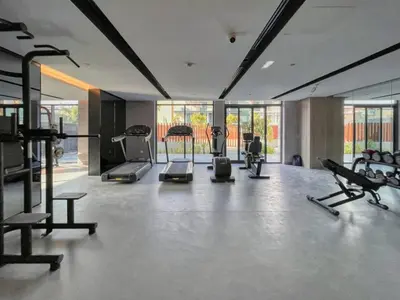 a gym with treadmills and machines in a room at HAVN - Smart Home Studio in Oxford 212, JVC in Dubai
