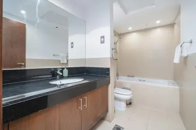 a bathroom with a sink and a toilet at HAVN - Studio Unit in 8 Boulevard, Downtown Dubai in Dubai