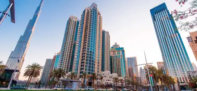 a city with tall skyscrapers and palm trees at HAVN - Studio Unit in 8 Boulevard, Downtown Dubai in Dubai