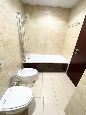a bathroom with a toilet and a tub and a sink at Seaside Spacious Studio with Vibrant Vibes in JBR By SWEET HOMES in Dubai