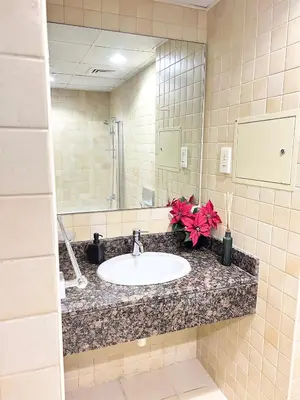 a bathroom counter with a sink and a mirror at Seaside Spacious Studio with Vibrant Vibes in JBR By SWEET HOMES in Dubai