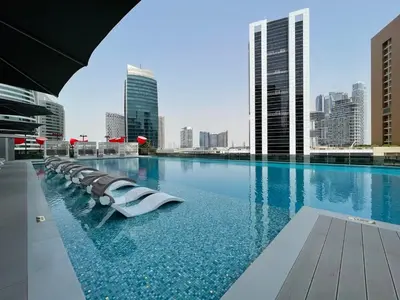 a swimming pool with a city skyline in the background at GuestReady – Downtown Studio l City View l Balcony in Dubai