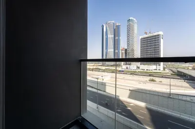 a room with a window with a view of a city at HAVN - Studio Unit in 15 Northside, Business Bay in Dubai