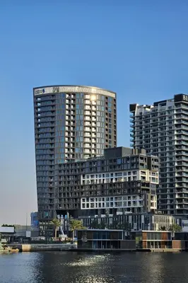 two tall buildings next to a body of water at HAVN - Studio Unit in 15 Northside, Business Bay in Dubai
