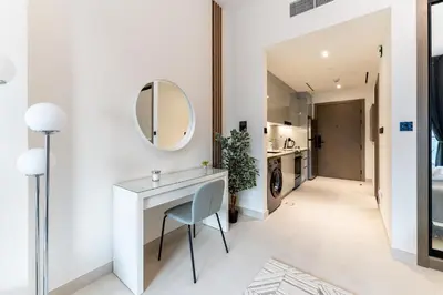 a white bathroom with a vanity and a mirror at HAVN - Studio in Business Bay, Burj Khalifa View in Dubai