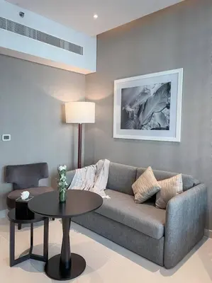 a living room with a couch and a table at Deluxe Studio Business Bay - Canal View - Gym & Pool in Dubai