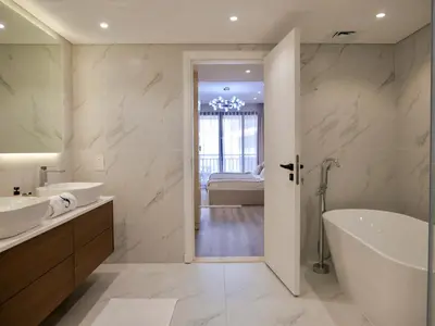 a bathroom with a tub and a sink and a bath tub at Ambient 1BR Apartment On The Beach at 5 Star Resort in Dubai