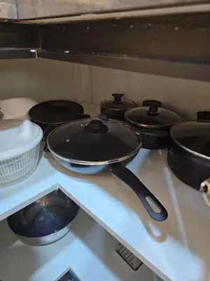 a stove top with pots and pans on it at Cozy Studio - Dubai Marina - 5 Min to Beach and Metro in Dubai