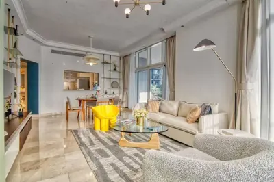 a living room with a couch and a table at The Smart Concierge - Avant in Dubai