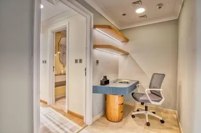 a home office with a blue desk and a chair at The Smart Concierge - Avant in Dubai