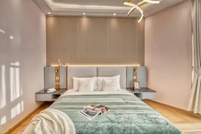 a bedroom with a large bed with a green blanket at The Smart Concierge - Avant in Dubai
