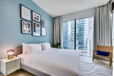 a bedroom with a large white bed and a large window at Luxurious apartment in Dubai Marina in Dubai